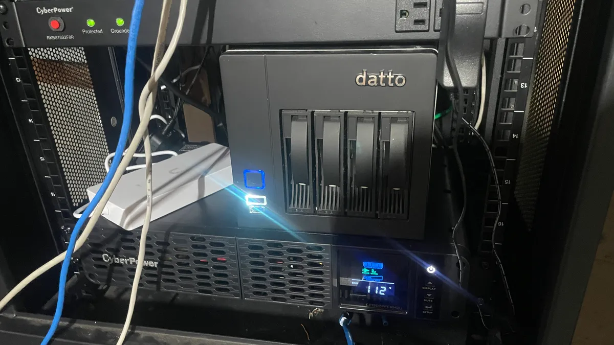 A backup appliance installed beside network and power equipment