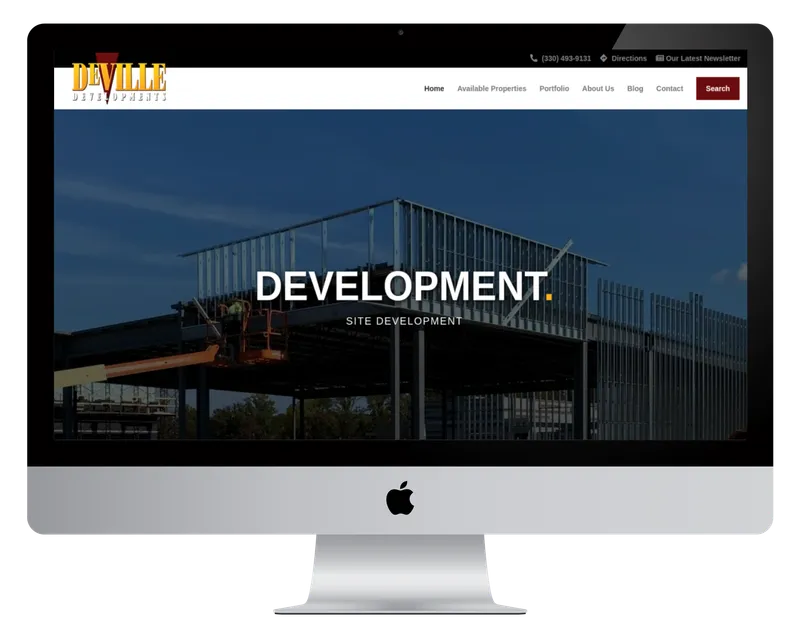 DeVille Developments homepage on a desktop monitor, with a steel-frame building under construction DeVille Developments homepage on a desktop monitor, with a steel-frame building under construction