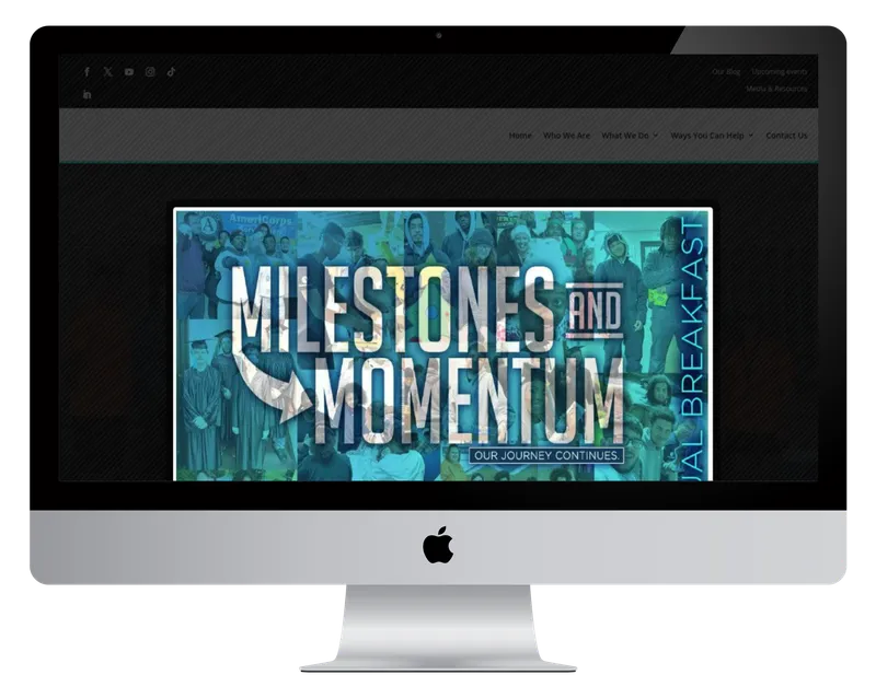 Project REBUILD homepage on a desktop monitor, with a Milestones and Momentum event banner Project REBUILD homepage on a desktop monitor, with a Milestones and Momentum event banner