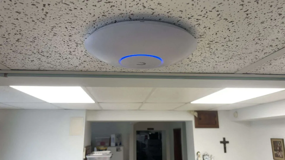 A ceiling-mounted wireless access point and an interior view at Sancta Clara Monastery A ceiling-mounted wireless access point and an interior view at Sancta Clara Monastery