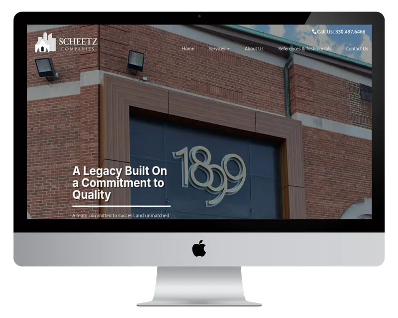 Scheetz & Co. homepage on a desktop monitor, with a brick building marked 1899 Scheetz & Co. homepage on a desktop monitor, with a brick building marked 1899