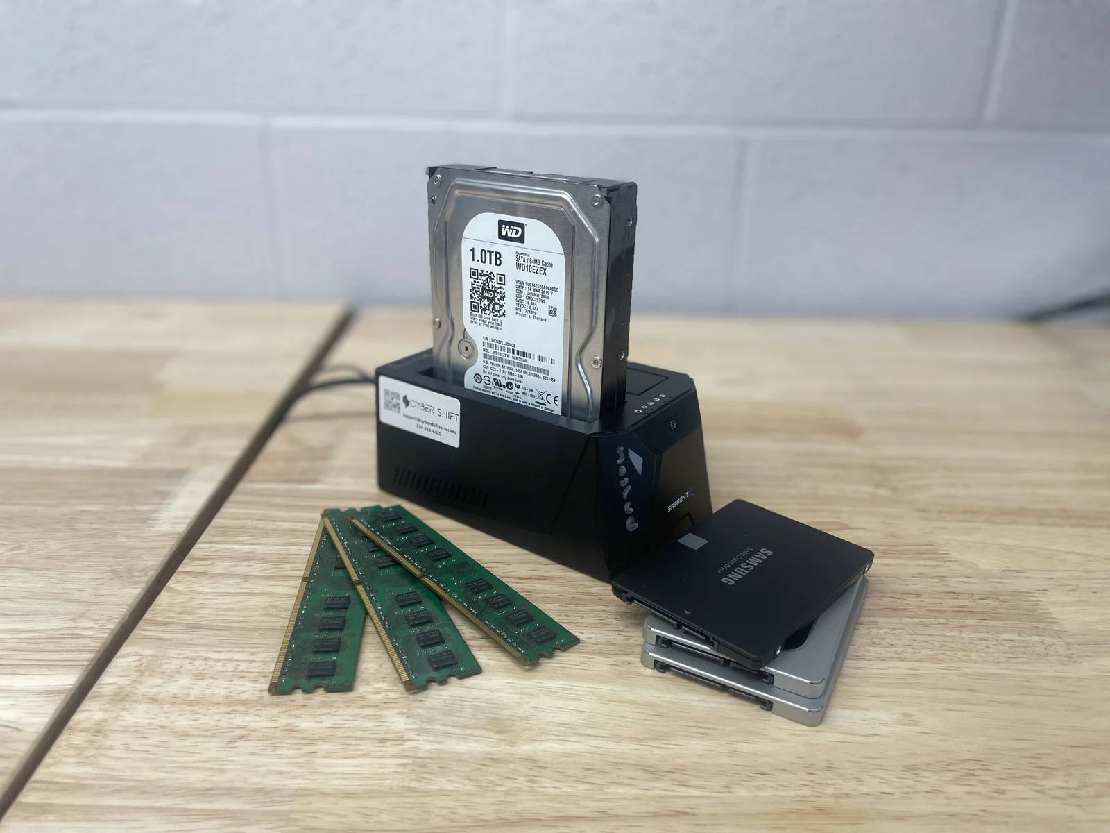 A drive dock, storage drives and memory modules on a workbench
