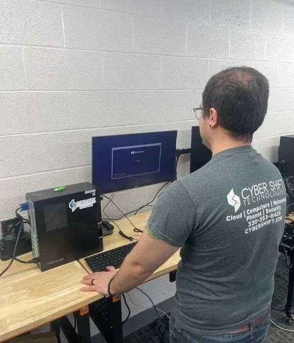 A Cyber Shift technician working at a business workstation