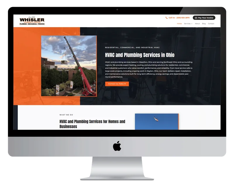 Whisler Plumbing & Heating homepage on a desktop monitor, with a crane lifting an HVAC unit onto a building Whisler Plumbing & Heating homepage on a desktop monitor, with a crane lifting an HVAC unit onto a building